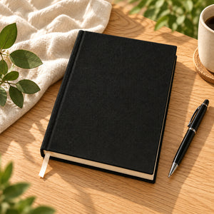 Blank black canvas notebook on a wood desk – A5, 7.9 x 5.5 in (20 x 14 cm), unprinted cover | Pamusan.com
