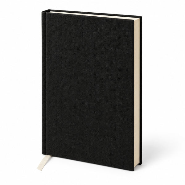 Blank black canvas notebook standing at a three-quarter angle, ribbon bookmark and cream page edges | Pamusan.com