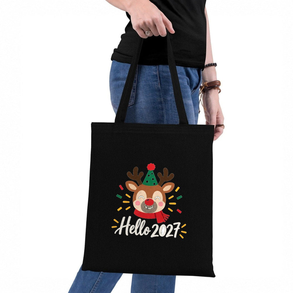 Bolsas navideñas colgadas en la pared: natural con ¡Feliz Navidad!, roja con Navidad dorada, negra con ¡Jo, jo, jo!