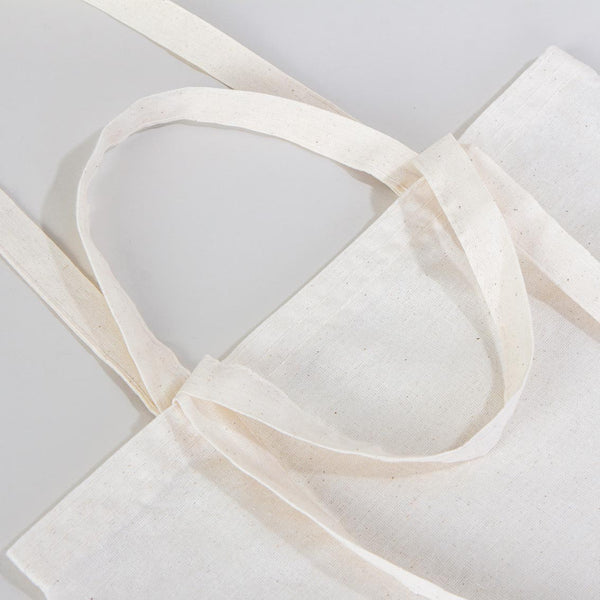 White tote bag with a handle on a light gray background